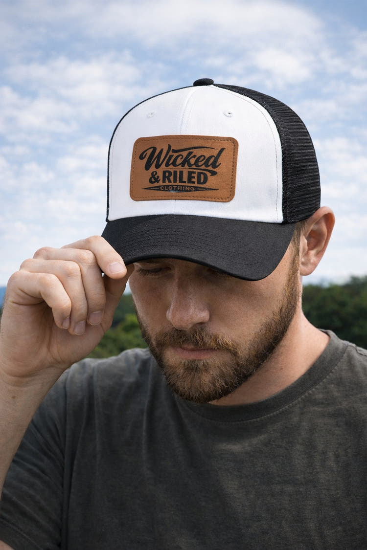 Wicked & Riled leather patch baseball cap featuring a distressed American flag logo on a classic hat design.