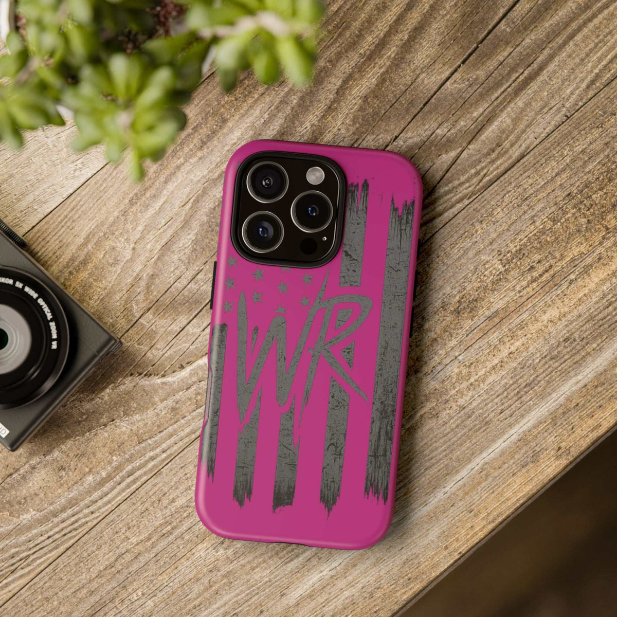 Pink 'WR' Flag Tough Phone Case by Printify with durable design and vibrant flag graphic on a sleek surface.