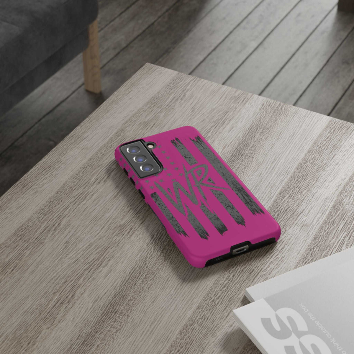 Pink 'WR' Flag Tough Phone Case by Printify with durable design and vibrant flag pattern on a sleek surface.