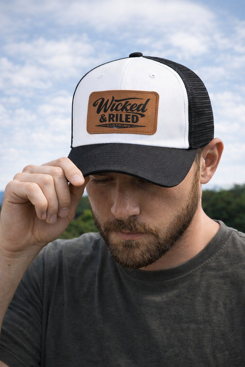 Wicked & Riled leather patch baseball cap featuring a distressed American flag logo on a classic hat design.