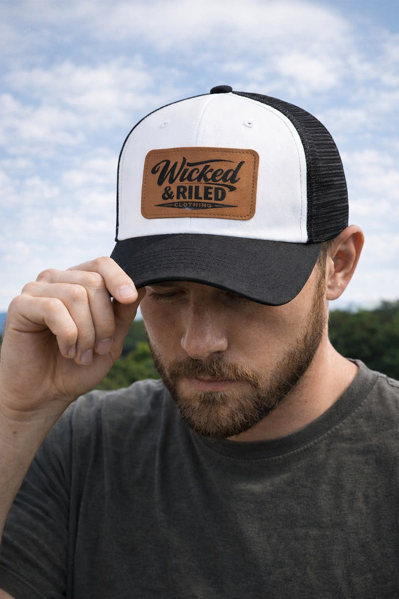 Wicked & Riled leather patch baseball cap featuring a distressed American flag logo on a classic hat design.